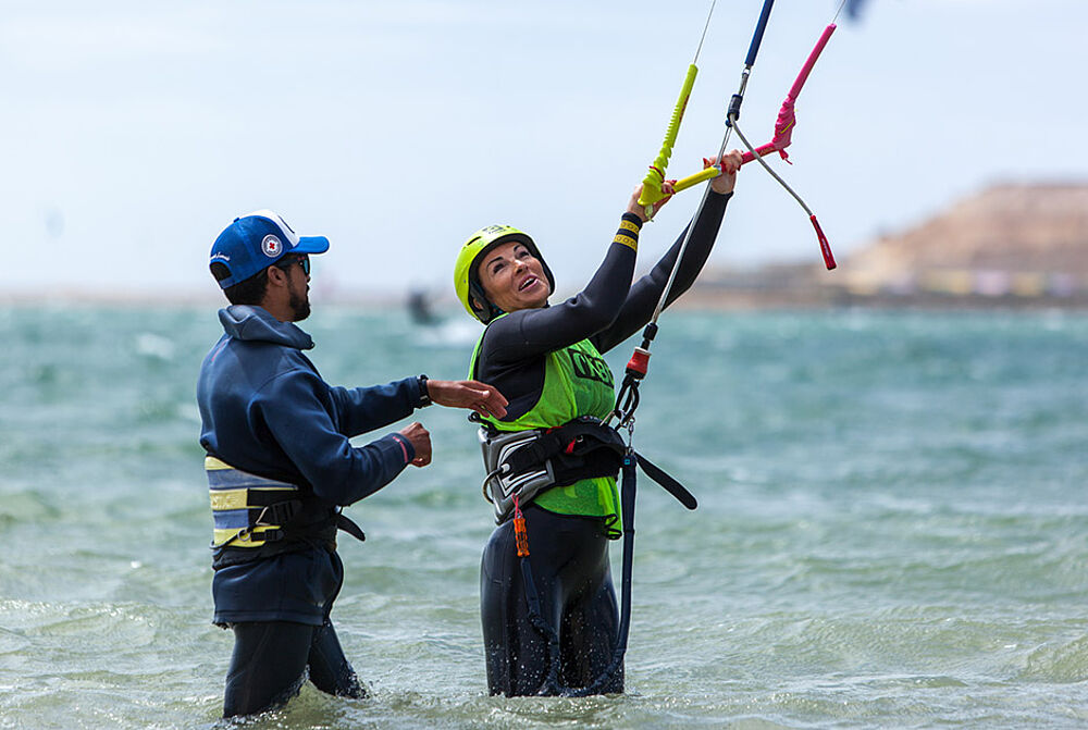 Kitesurf instructor and student in hip deep water