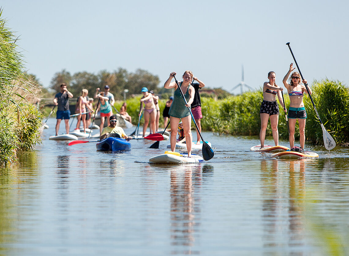 Kitesurf Holland013 stand-up paddleboarding (SUP) with group on calm waters - water sports Holland travel destination