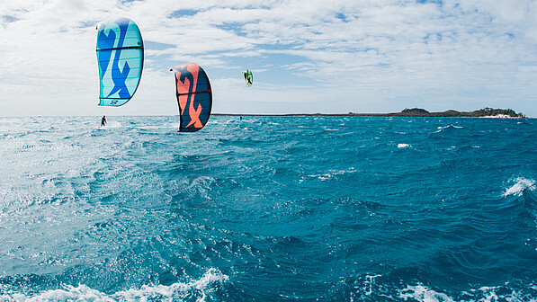 Two kitesurfers with F-ONE kites on open sea - kiteboarding equipment