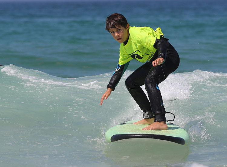 Surfkurs surfing lesson on beach waves - KBC Kitesurf Center Tarifa professional kiteboarding water sports training