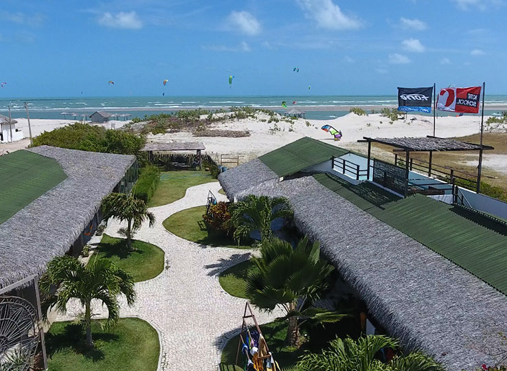 Parajuru kiteboarding resort with green roofs, palm garden and beach - perfect kitesurfing travel destination Brazil