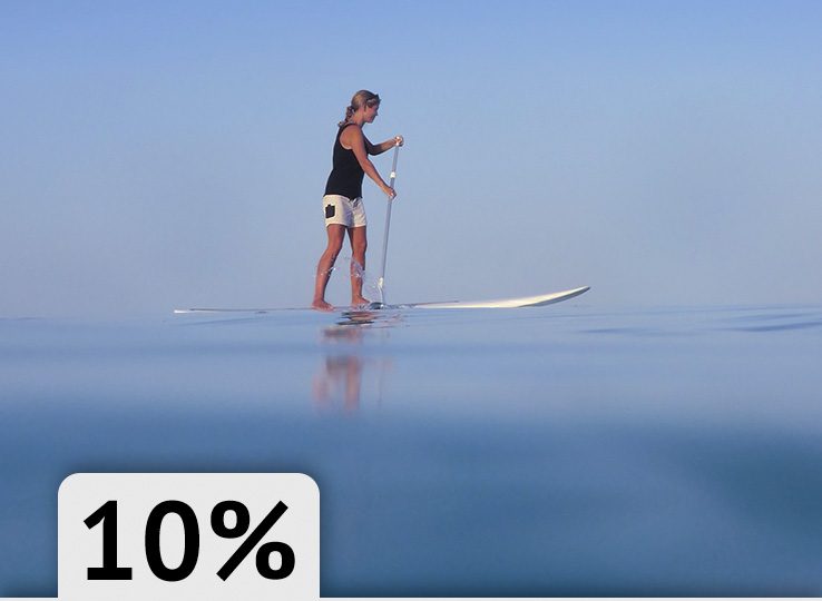 SUP paddleboarding on calm water with perfect conditions for water sports and kitesurfing at beach destination
